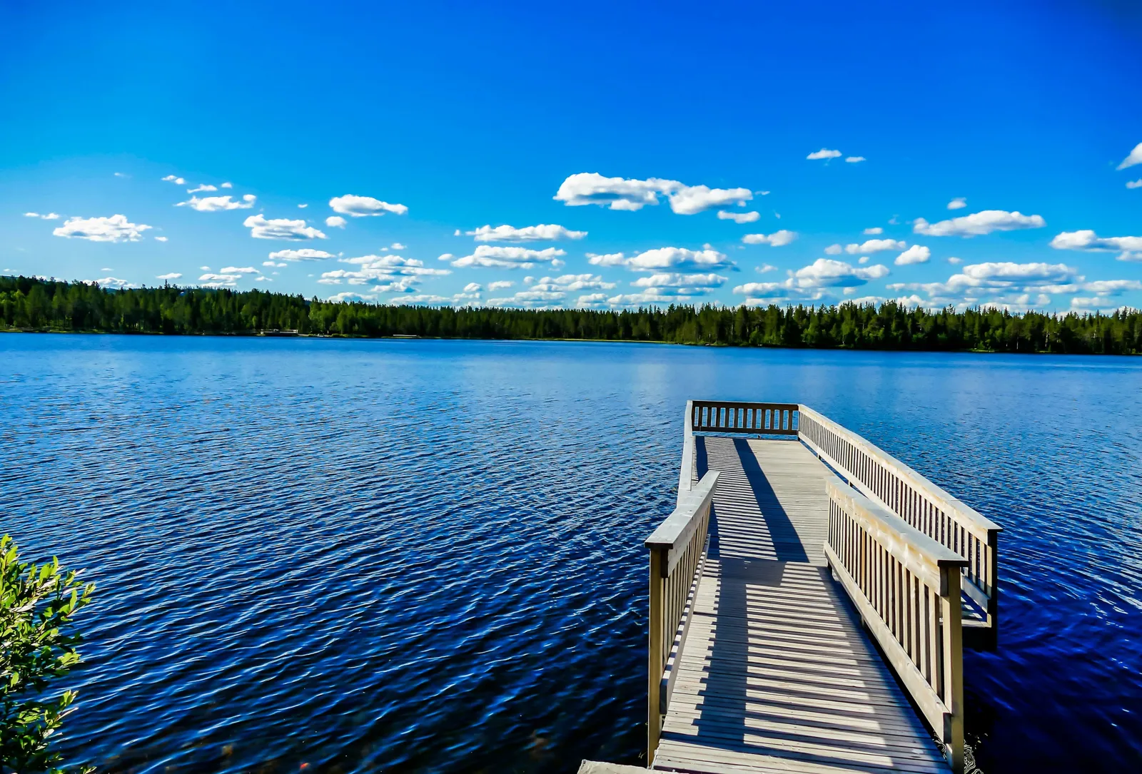 Wooden jetty on a forest-lined lake in Sweden
